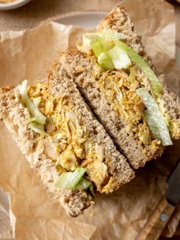 Vegan coronation chicken sandwich with lettuce and black pepper.