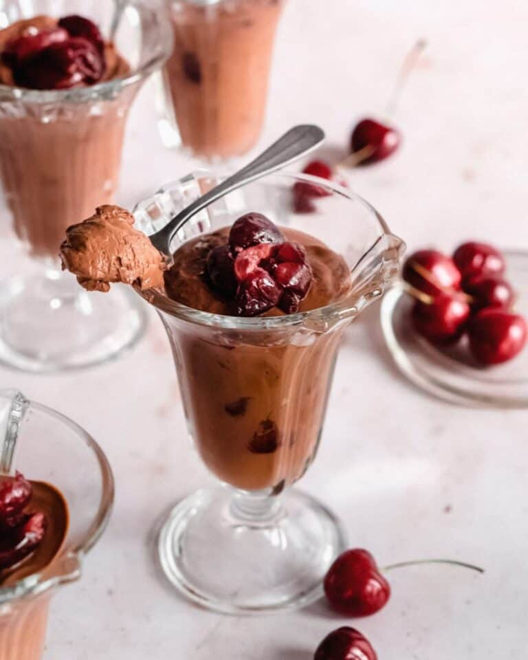 Chocolate mousse with cherries in a sundae glass.
