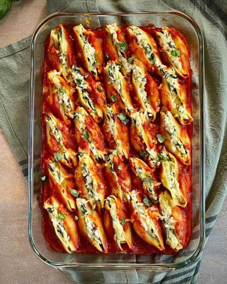 Filled pasta shells in a large glass dish.
