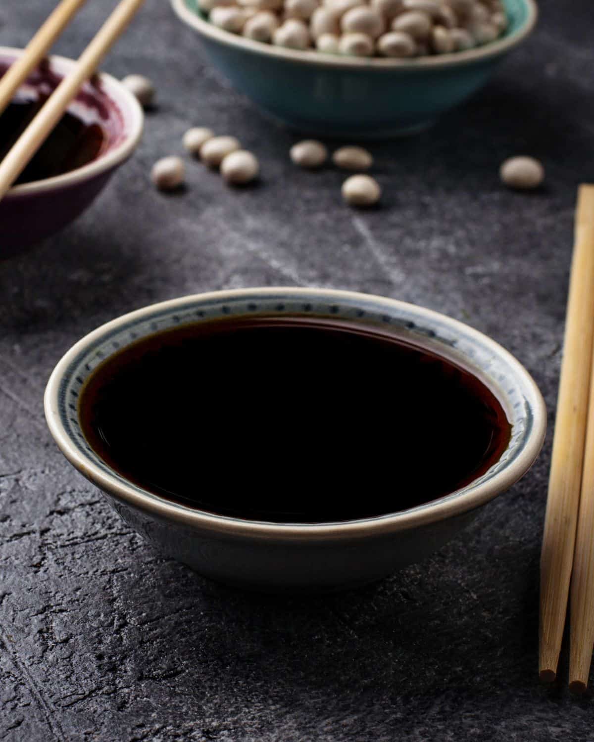 Tamari in a bowl with chopsticks beside it.