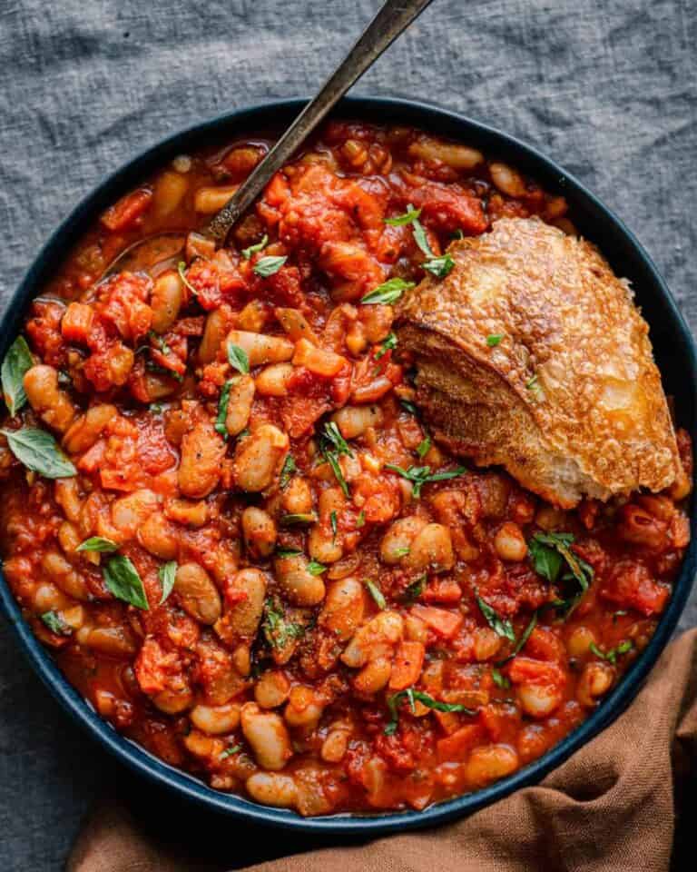 Tuscan bean stew in a bowl with crusty bread.