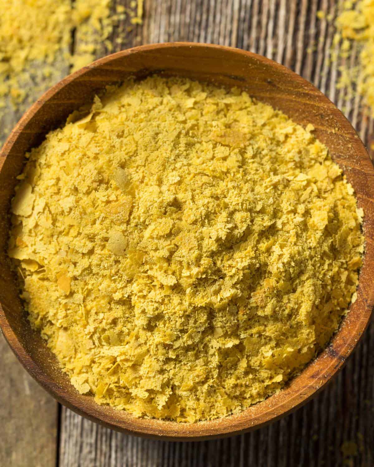 Nutritional yeast in a wooden bowl.