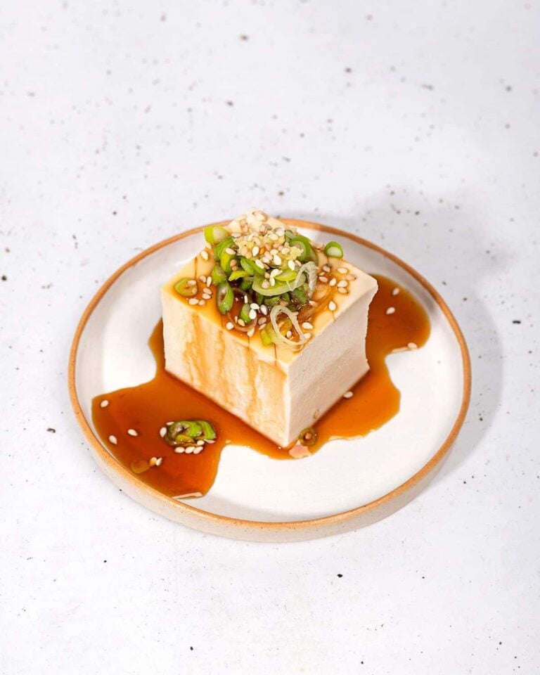 Japanese silken tofu topped with soy sauce, sesame seeds and green onion.