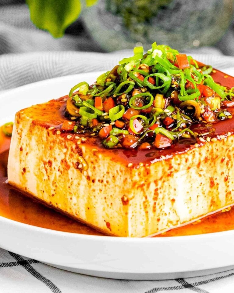 Korean silken tofu covered with sauce and spring onions.