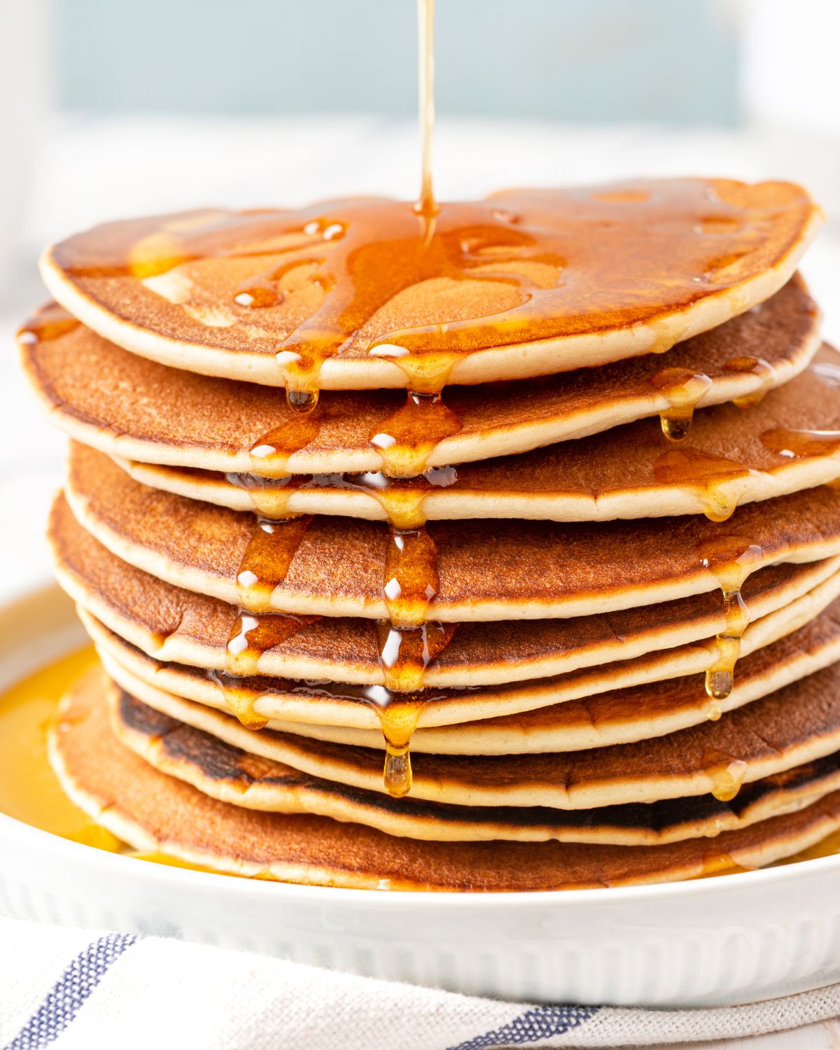 A stack of pancakes with syrup.