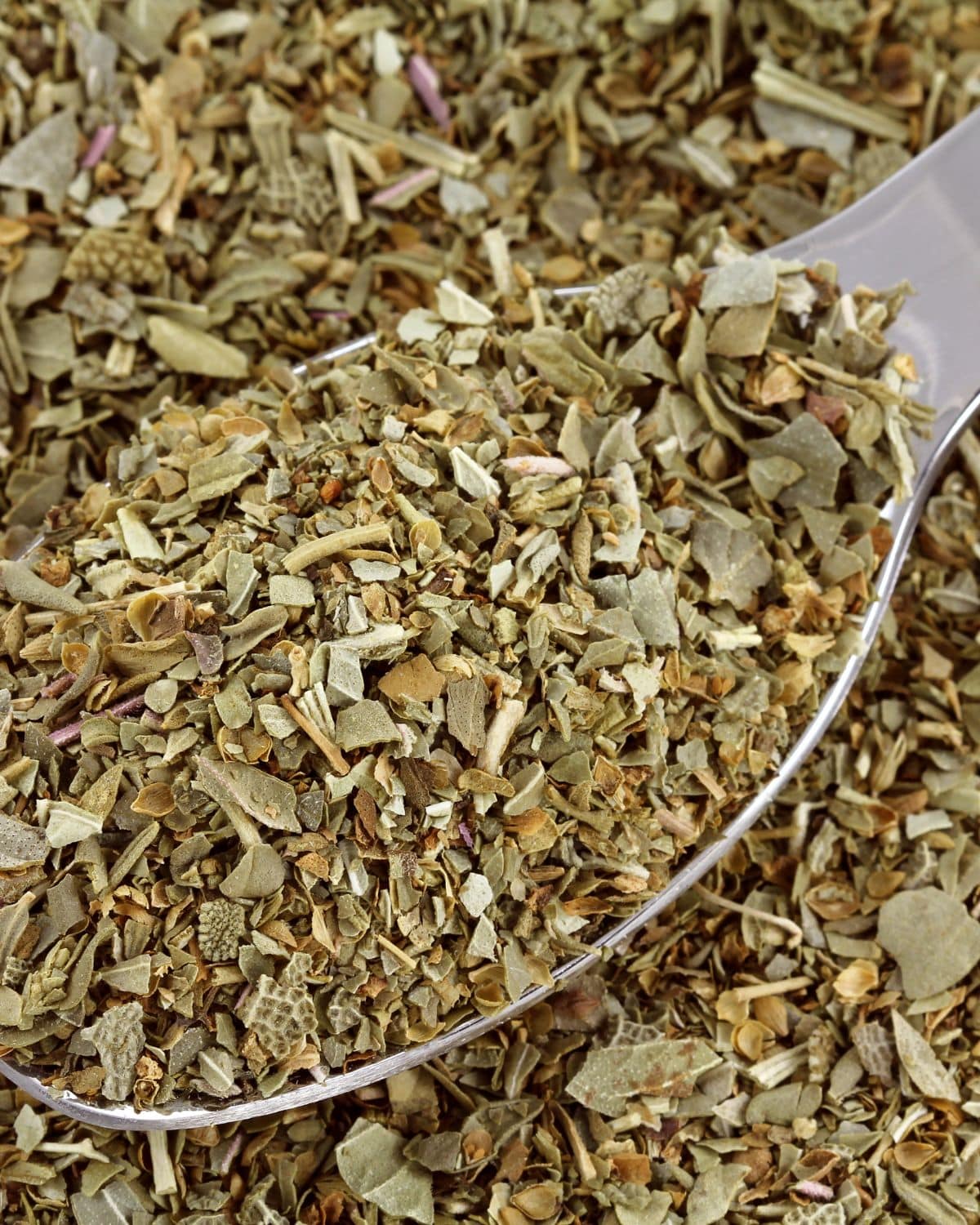 Dried herbs on a spoon.