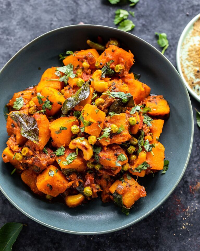 Butternut squash and pea sabzi topped with cashews and curry leaves.