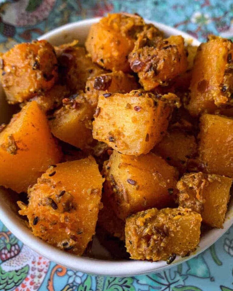 Sauteed butternut squash with Indian spices piled high in a bowl.