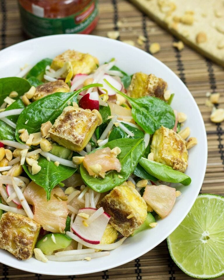 Asian tofu salad in a bowl with spinach.