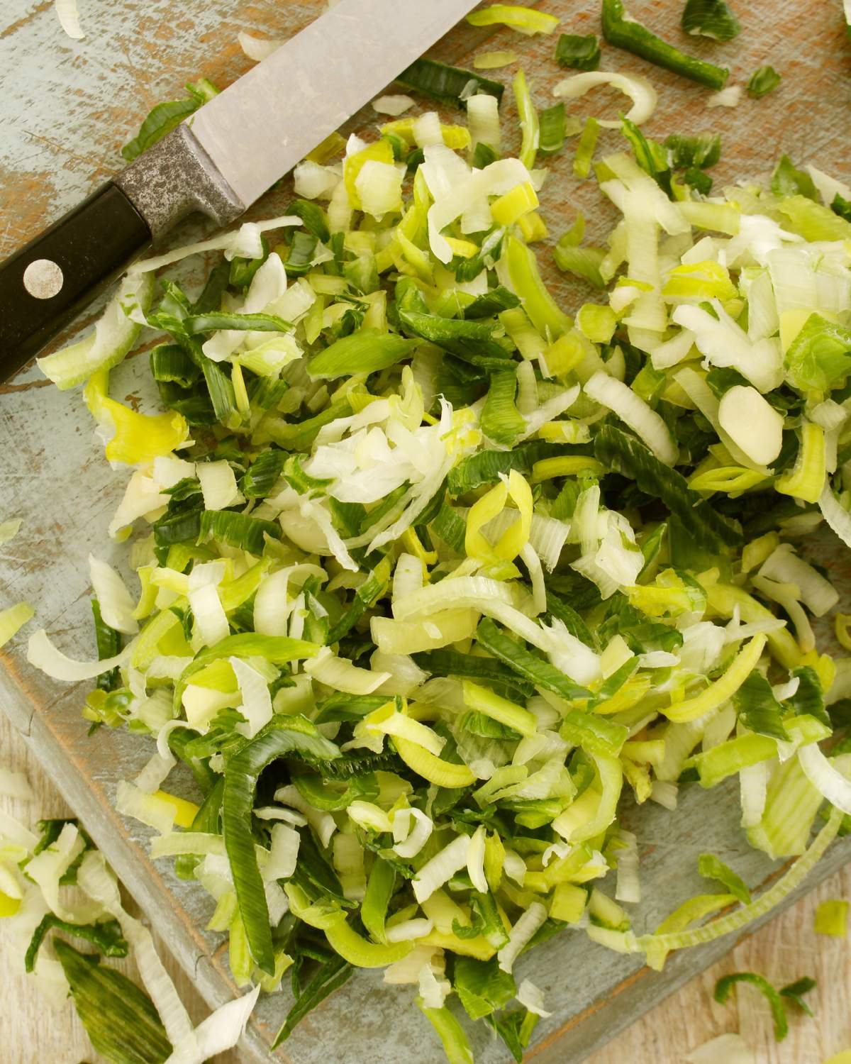 Chopped leeks on a cutting board.