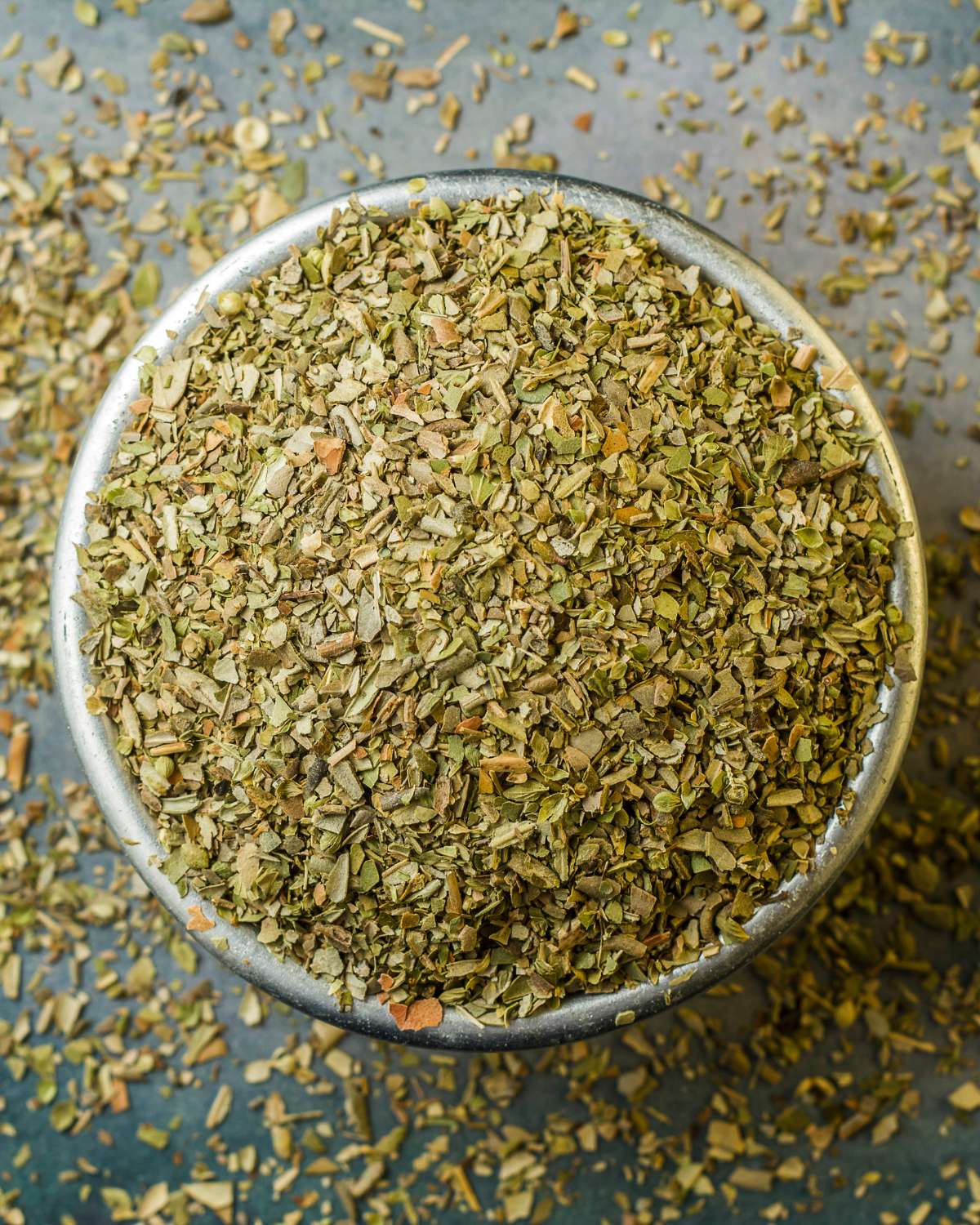 Dried oregano in a metal bowl.