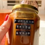 Pumpkin spice syrup in a jar with a Pinterest title above.