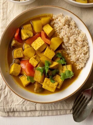 Vegan Thai yellow curry in a bowl with rice.